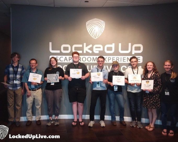 Students from Veritas Theology Insitute pose for a photo after successfully completing Locked Up escape room. 