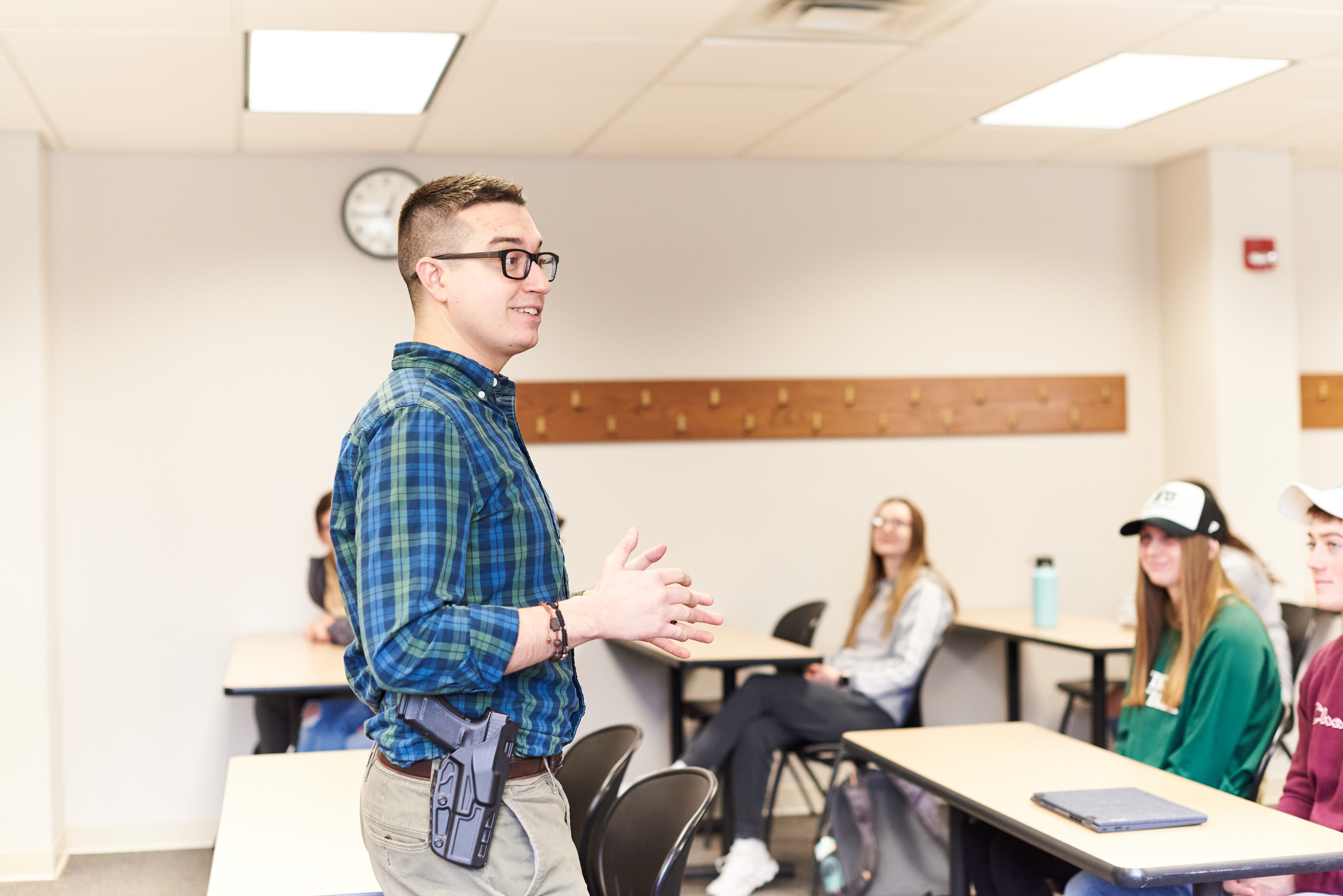 A law enforcement officer teaches Criminal Justice  students in a classroom.