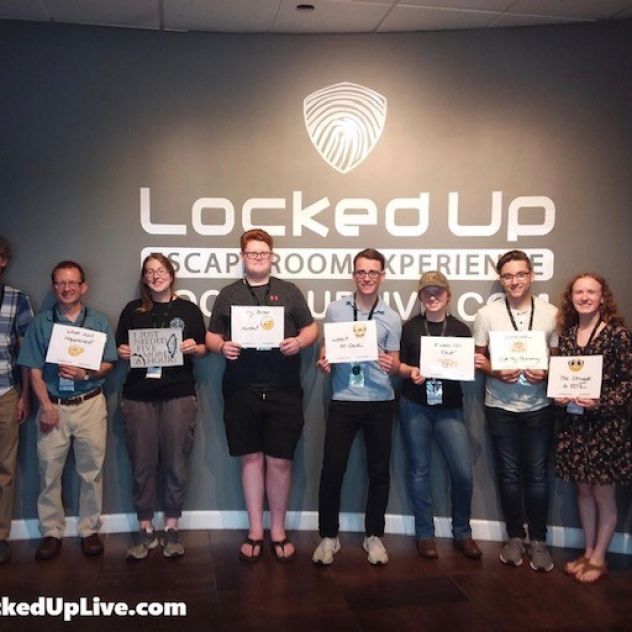 Students from Veritas Theology Insitute pose for a photo after successfully completing Locked Up escape room. 