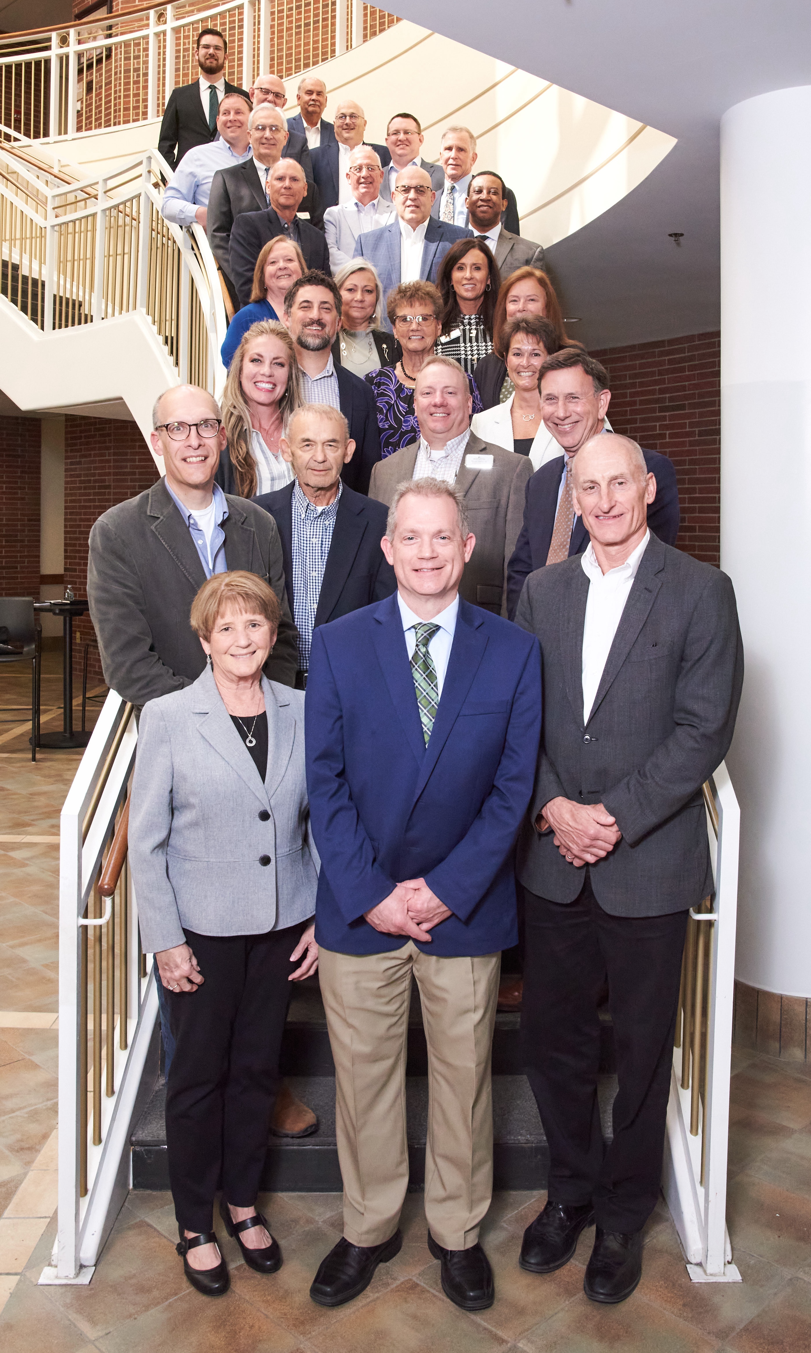 The 2025 Board of Trustees for Huntington University standing on the staircase of Dowden Science Hall.