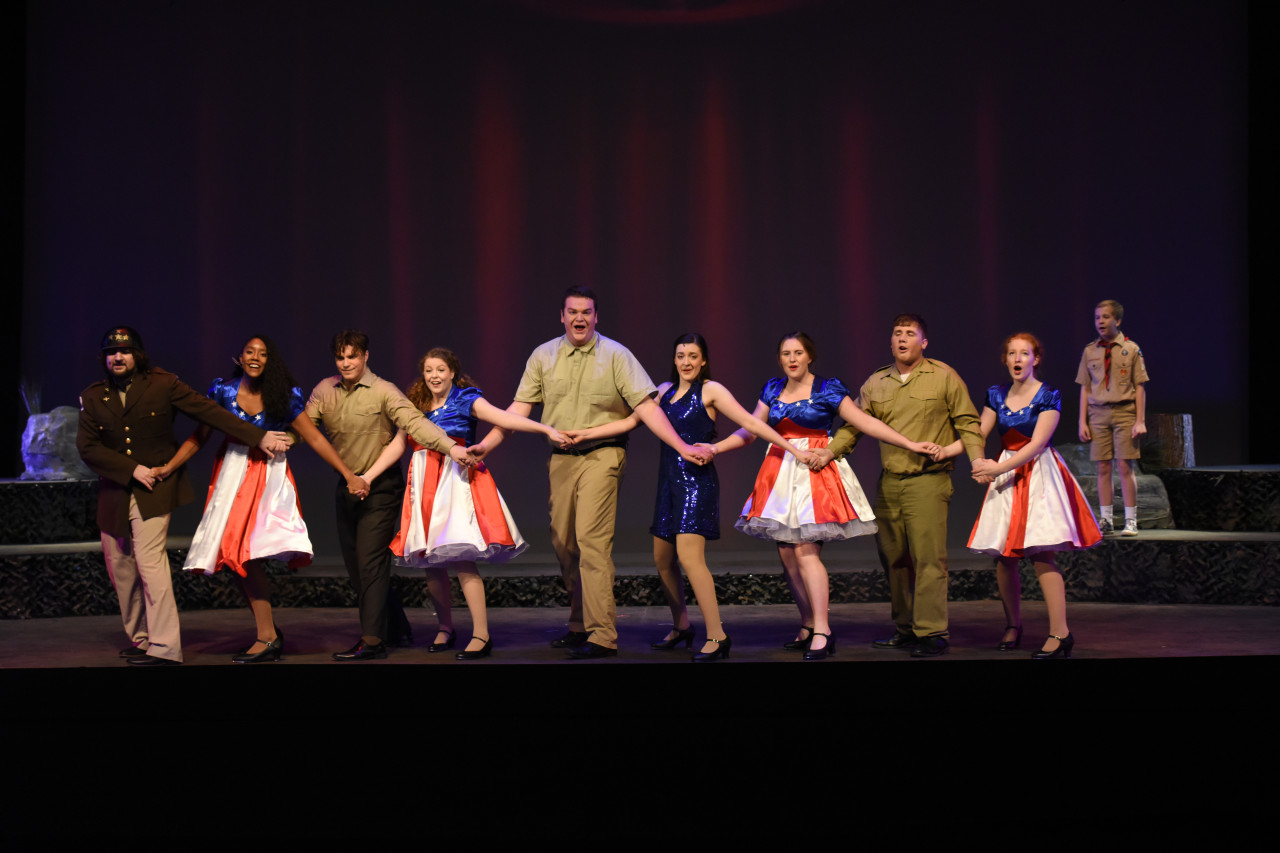 A cast of HU Theatre students performs on stage
