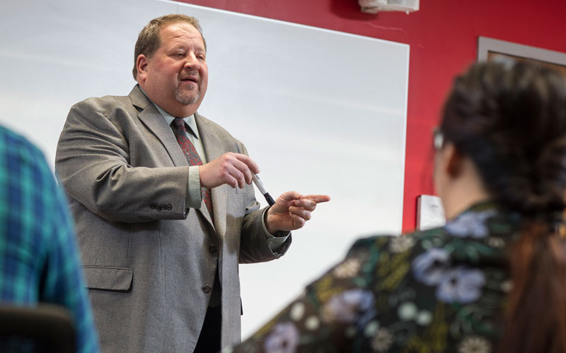 HU professor, Dr. Brock Zehr teaching a Business class.