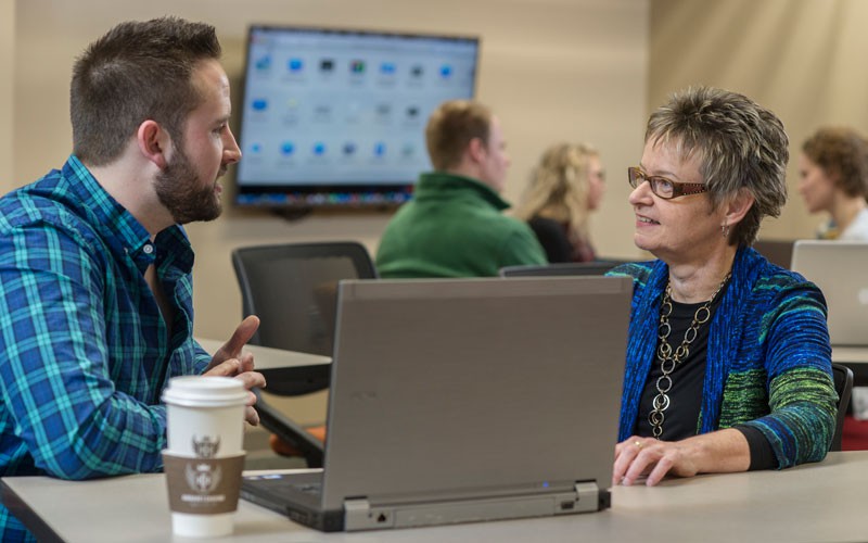 HU professor having a conversation with an HU student.