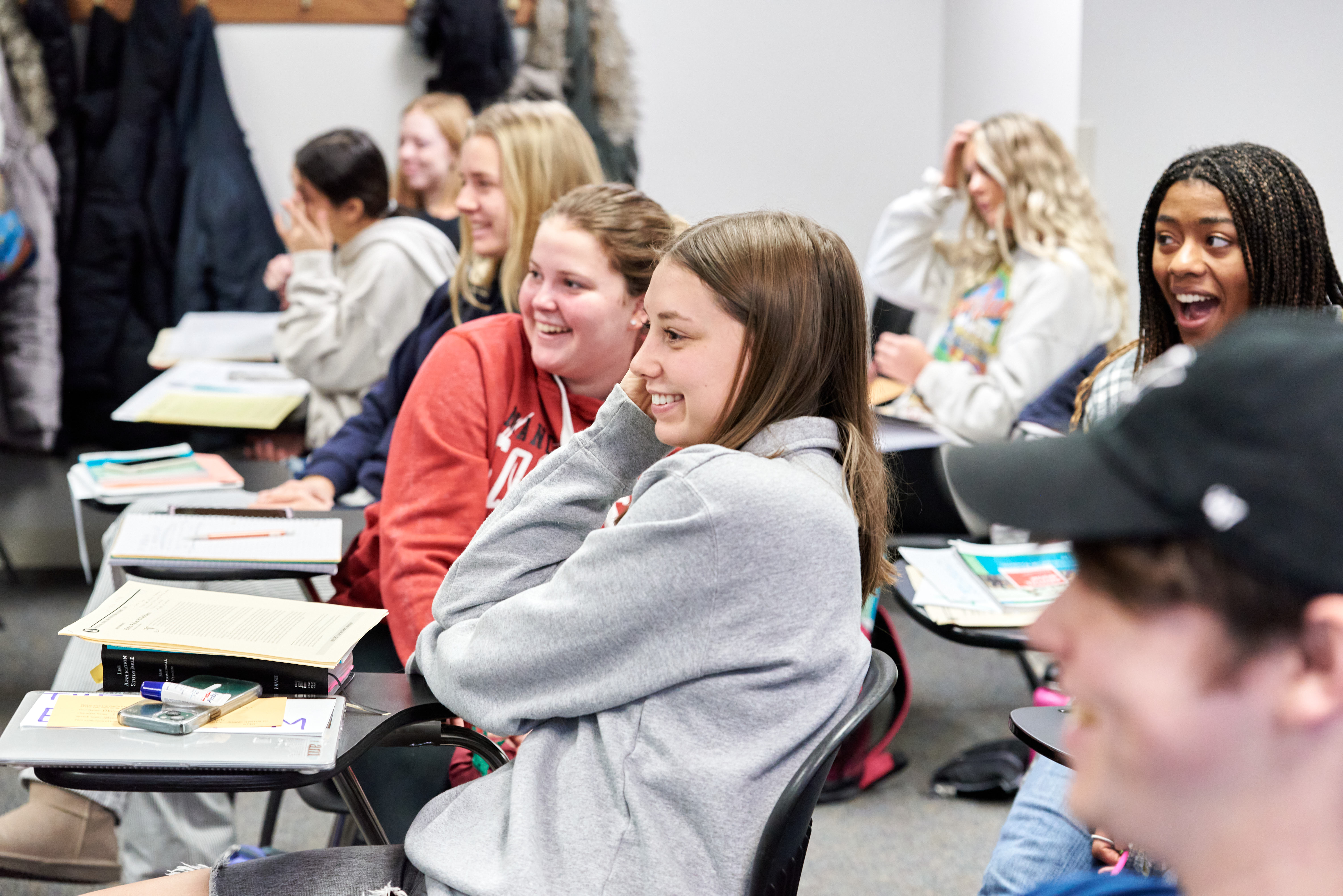 Students smiling in a classroom setting