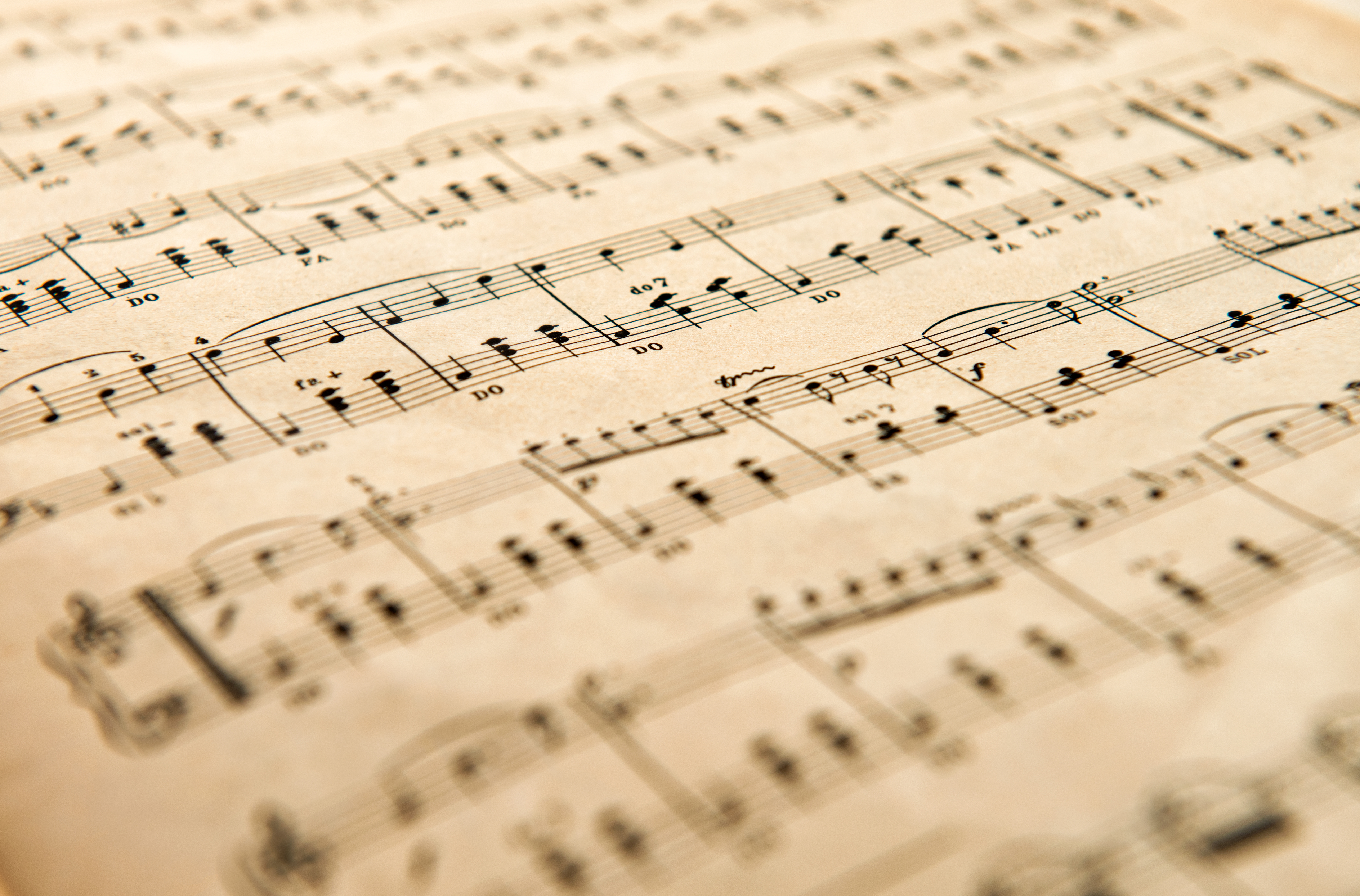 A sepia-toned photo of instrumental sheet music.