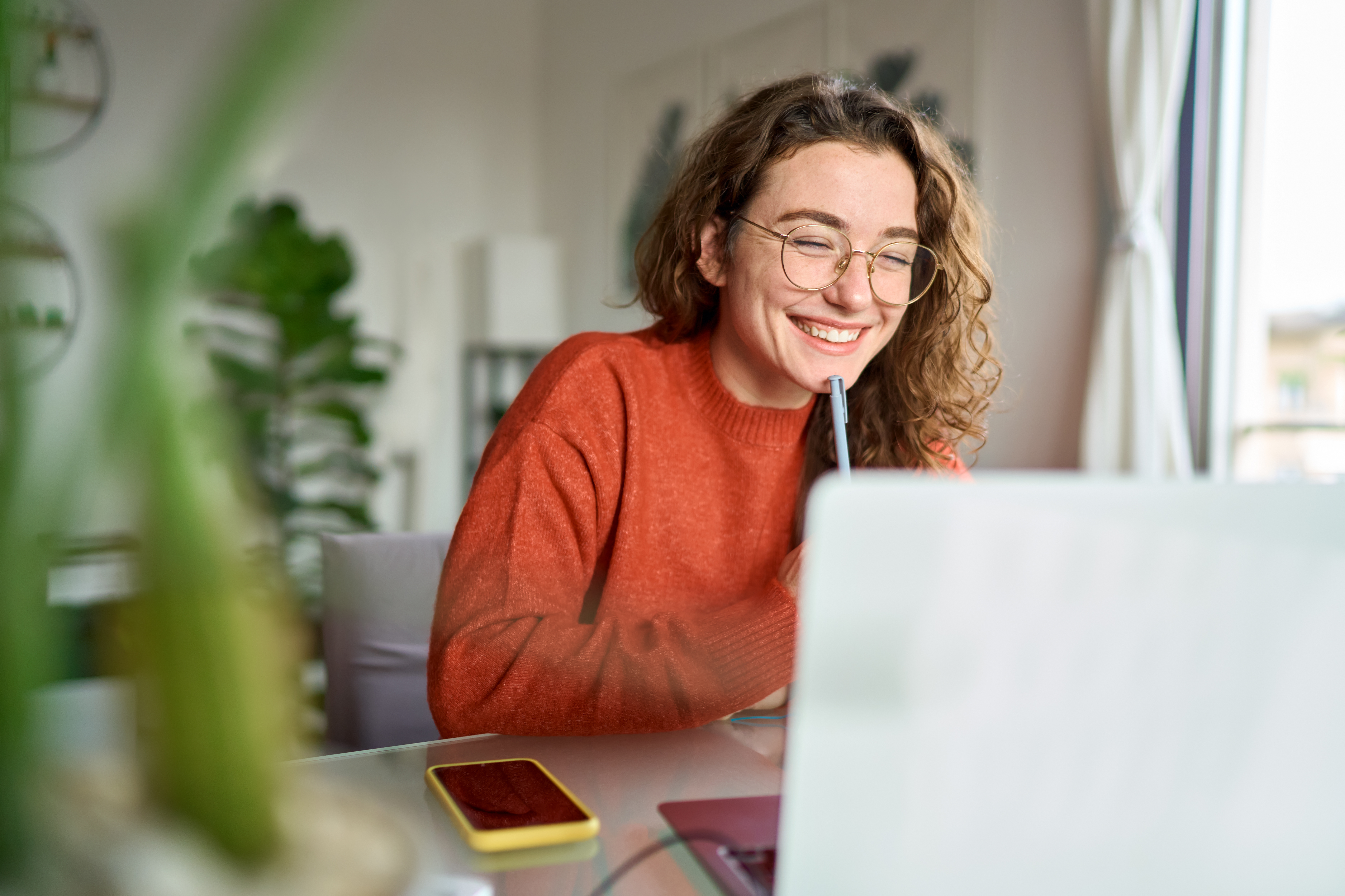 A student interacts with a laptop for her online class.