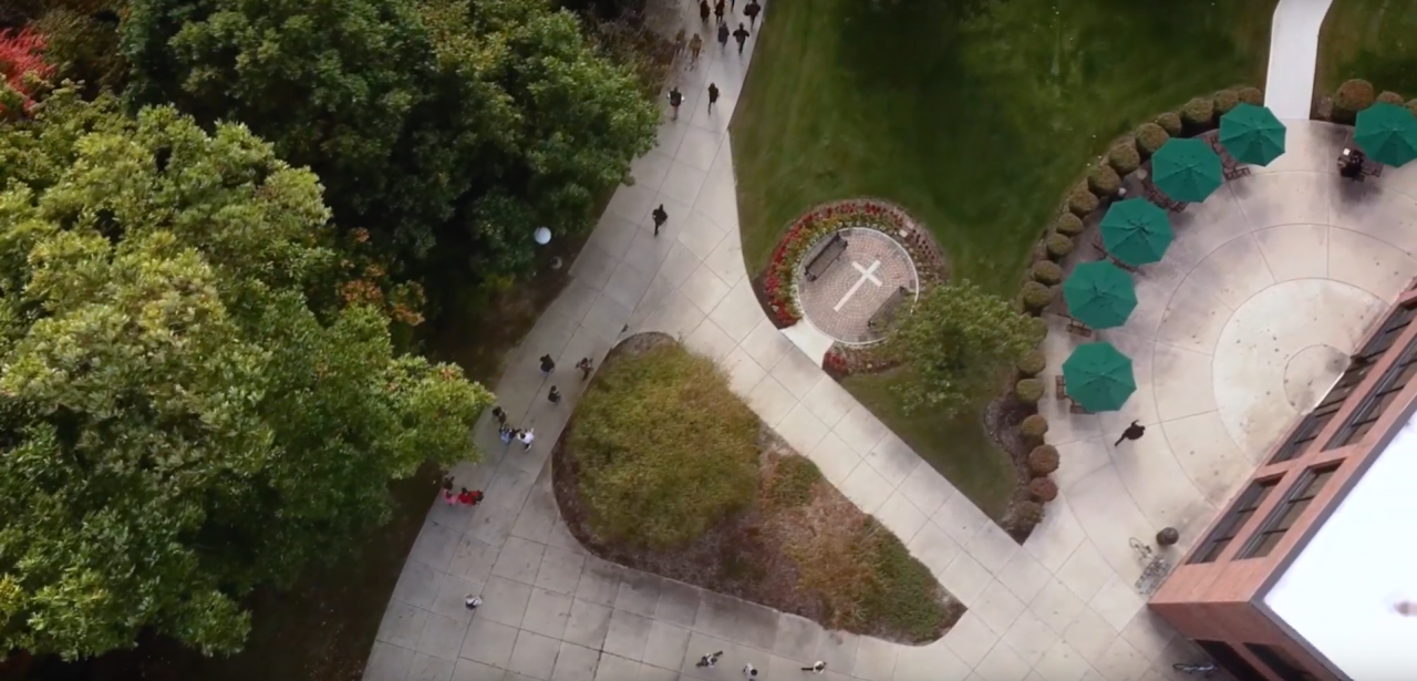 Image of Huntington University campus showing students walking along paths.