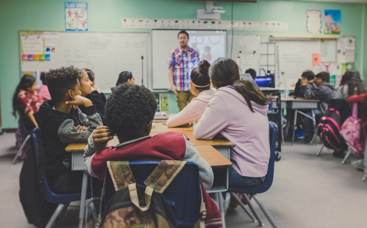 Multiple students sitting in a classroom earning tesol degree